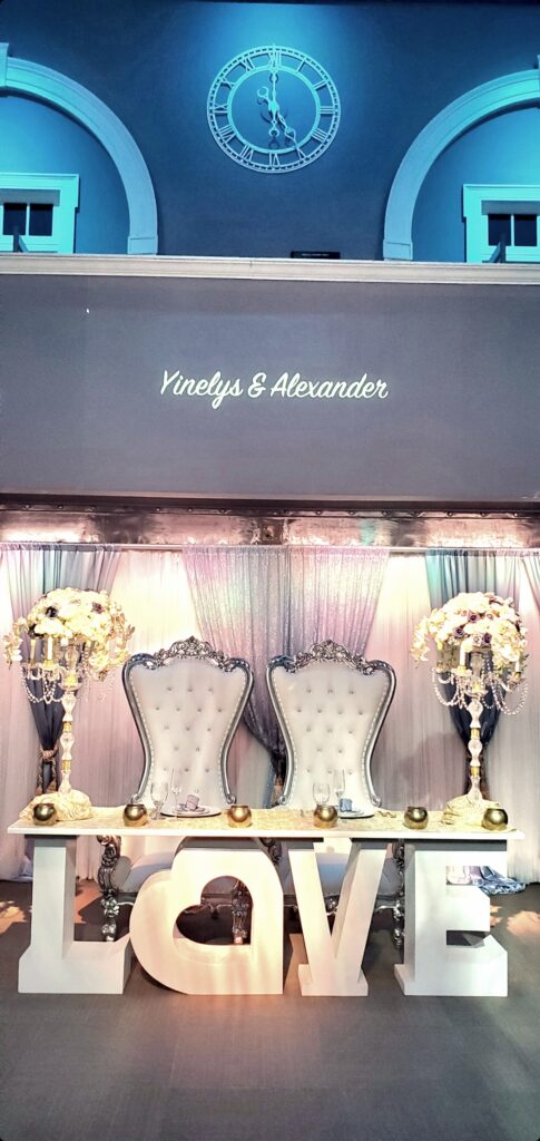 romantic ballroom wedding reception with illuminated LOVE decor