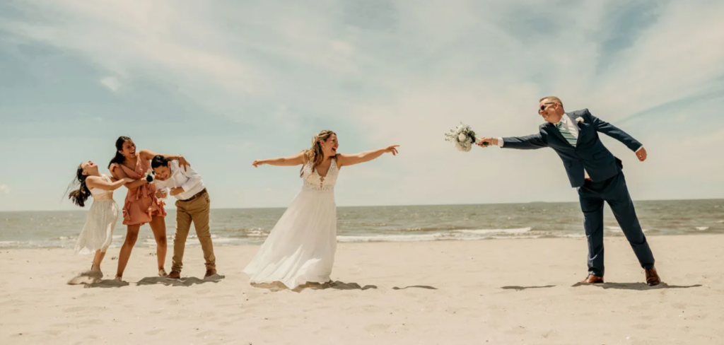 Funny wedding moment with candid interaction between couple on a beach