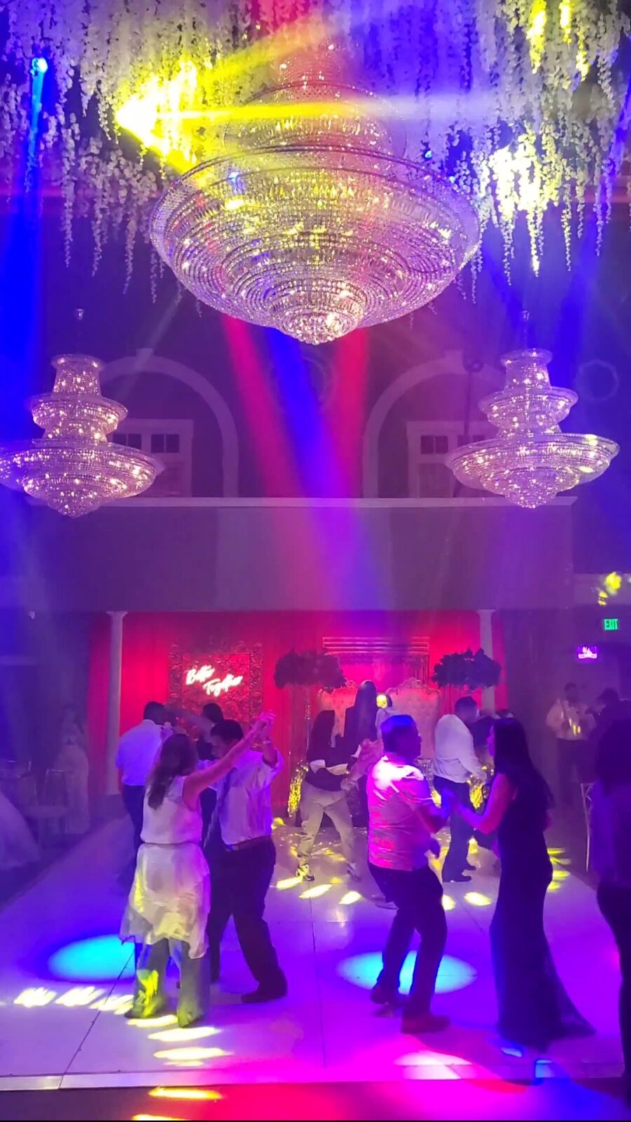 Cinematic wedding lighting and suspended floral decor inside Connecticut ballroom venue