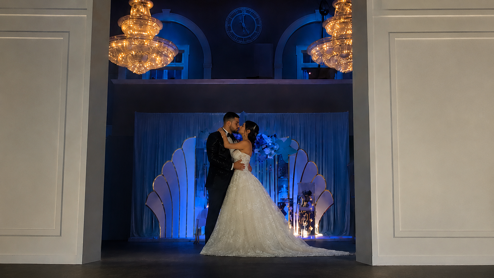 Elegant wedding couple beneath chandeliers at Silver City Ballroom in Connecticut